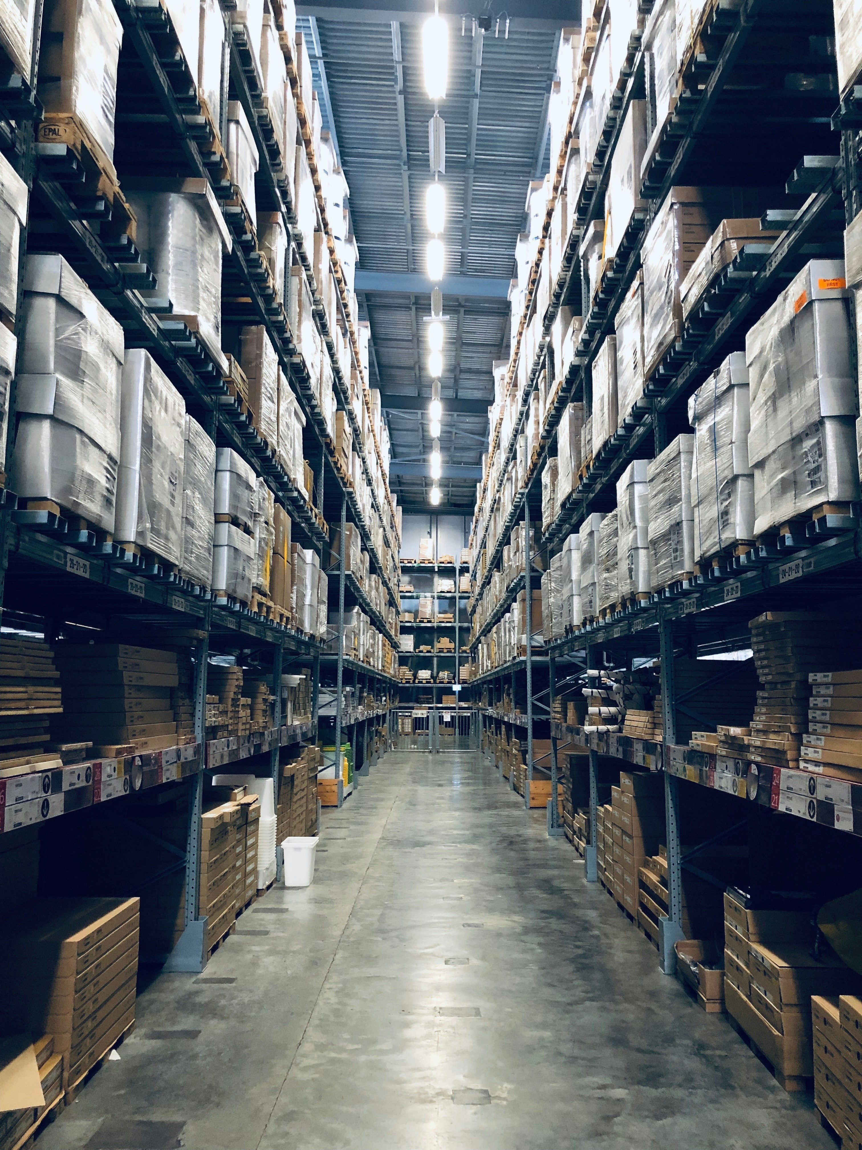 Warehouse logistics environment — stacked cartons on tall industrial shelving racks